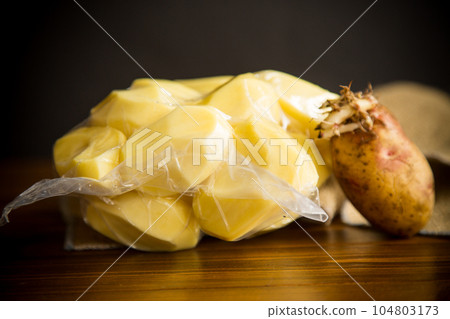 peeled potatoes closed in a vacuum bag and old sprouted potatoes peeled potatoes closed in a vacuum bag and old sprouted potatoes 104803173