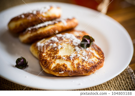sweet fried cottage cheese pancakes in a plate 104803188