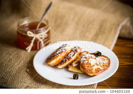 sweet fried cottage cheese pancakes in a plate 104803189
