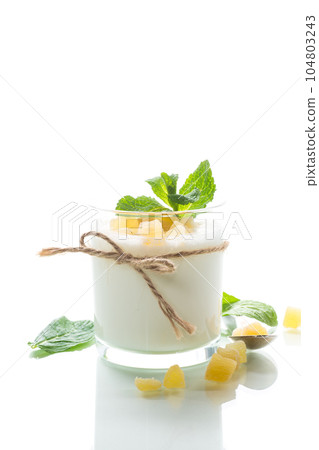 Sweet homemade yogurt with candied fruits in a glass Sweet homemade yogurt with candied fruits in a glass 104803243