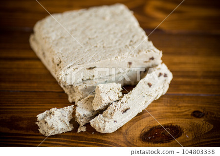 piece of sweet halva on a wooden table 104803338