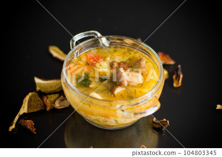 vegetarian vegetable soup with porcini mushrooms in a glass bowl 104803345