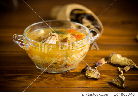 vegetarian vegetable soup with porcini mushrooms in a glass bowl 104803346
