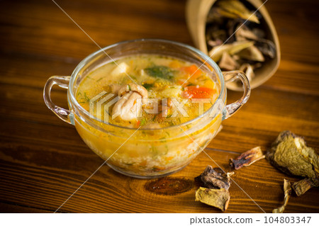 vegetarian vegetable soup with porcini mushrooms in a glass bowl vegetarian vegetable soup with porcini mushrooms in a glass bowl 104803347