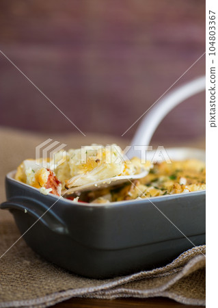 baked cauliflower with chicken fillet and vegetables topped with cheese baked cauliflower with chicken fillet and vegetables topped with cheese 104803367