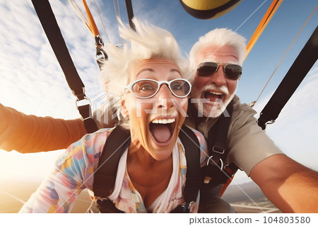 Selfie skydiving tandem of an elderly couple 104803580