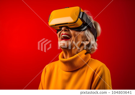 Senior woman having fun with virtual reality glasses. Old people using new headset goggles trends technology Senior woman having fun with virtual reality glasses. Old people using new headset goggles trends technology 104803641