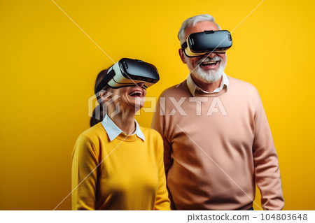 Senior mature couple having fun with virtual reality glasses. Old people using new headset goggles trends technology Senior mature couple having fun with virtual reality glasses. Old people using new headset goggles trends technology 104803648
