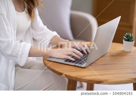 Business woman working from home. work online on laptop. Asian businesswoman working on sofa online business with social distancing laptop online meeting. Business woman working from home. work online on laptop. Asian businesswoman working on sofa online business with social distancing laptop online meeting. 104804191