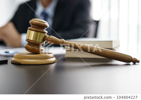Lawyer Legal counsel presents to the client a signed contract with gavel and legal law. justice and lawyer Business partnership meeting concept. Lawyer Legal counsel presents to the client a signed contract with gavel and legal law. justice and lawyer Business partnership meeting concept. 104804227