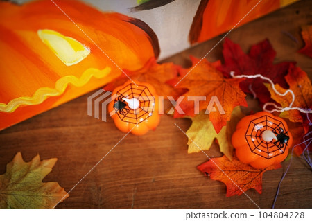 Halloween decorations background. Halloween Scary pumpkin head on wooden table Halloween holiday Halloween decorations background. Halloween Scary pumpkin head on wooden table Halloween holiday 104804228