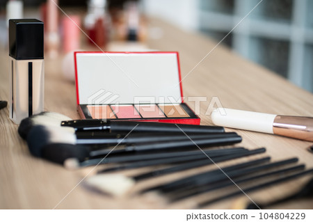 Decorative cosmetics makeup set on wood table. Set of luxury makeup product background Decorative cosmetics makeup set on wood table. Set of luxury makeup product background 104804229