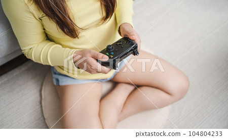 Young Asian woman gamer controller video console playing holding hobby playful Online Video Game enjoyment eSport Cyber Games Internet Young Asian woman gamer controller video console playing holding hobby playful Online Video Game enjoyment eSport Cyber Games Internet 104804233