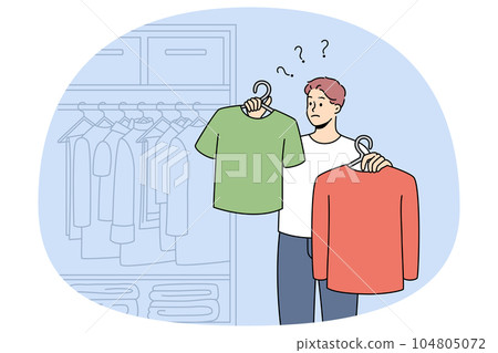 Man choose what to wear in wardrobe 104805072