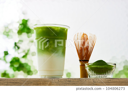 Matcha latte, pouring matcha into milk with ice Matcha latte, pouring matcha into milk with ice 104806273