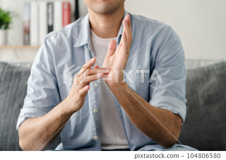 Happy young deaf man using sign Language to communicate with other people.. Happy young deaf man using sign Language to communicate with other people.. 104806580