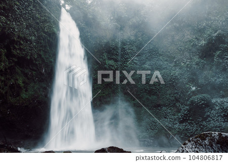 Waterfall with powerful flow in Bali, Indonesia. Tropical nature and epic waterfall 104806817