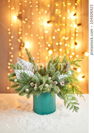 Floral arrangement in a round box with a live spruce for decorating the house for the Christmas holidays. Christmas wooden box with fir branches for the holiday. The new year celebration. European Floral arrangement in a round box with a live spruce for decorating the house for the Christmas holidays. Christmas wooden box with fir branches for the holiday. The new year celebration. European 104806925