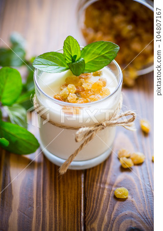 sweet homemade yogurt with raisins in a glass sweet homemade yogurt with raisins in a glass 104807167