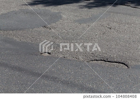 asphalt damaged road 104808408