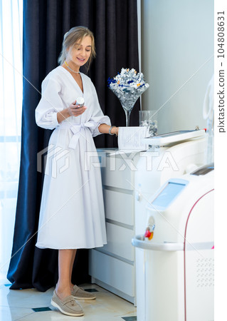 Cosmetologist in beauty clinic preparing for facial skin treatment procedures. Cosmetologist in beauty clinic preparing for facial skin treatment procedures. 104808631