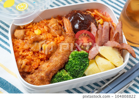 A delicious bento box for children, chicken rice, fried shrimp, hamburger steak A delicious bento box for children, chicken rice, fried shrimp, hamburger steak 104808822