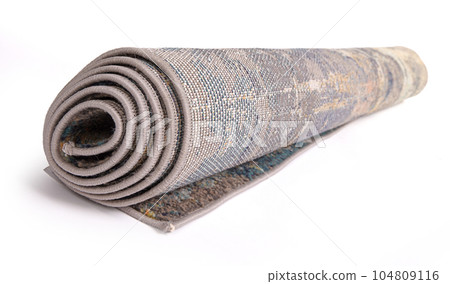 Rolled up carpet on a white background Rolled up carpet on a white background 104809116
