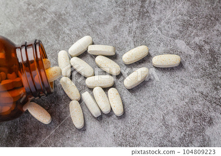 Medical pills spilling open drug bottle Medical pills spilling open drug bottle 104809223