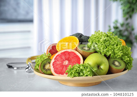 Plate of fruits on table. Diet plan from nutritionist Plate of fruits on table. Diet plan from nutritionist 104810125