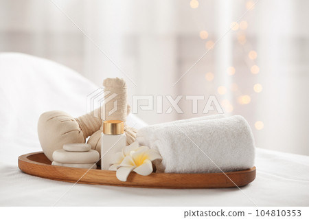 Beautiful composition with spa stones on white fabric 104810353