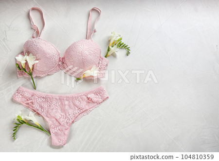 Sexy women's underwear and flowers on light background, flat lay. Space for text 104810359
