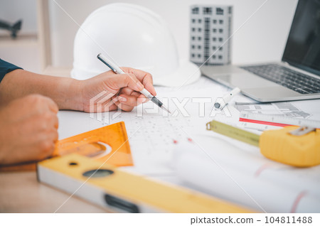 engineer working in office with blueprints, inspection in workplace for architectural plan, construction project ,Business construction 104811488