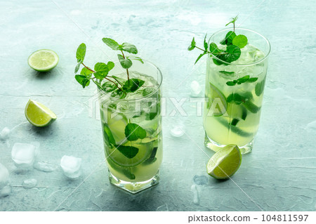 Mojito cocktail. Summer cold drink with lime, fresh mint, and ice. Cool beverage Mojito cocktail. Summer cold drink with lime, fresh mint, and ice. Cool beverage 104811597