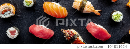 Sushi panorama. Nigiri with eel, tuna, salmon and shrimp, overhead 104811624