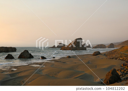 View of the cliffs and the Pacific Ocean during sunset. 104812202