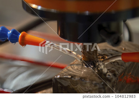 Close up scene the EDM machine working process with copper electrode. Close up scene the EDM machine working process with copper electrode. 104812983