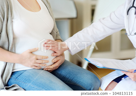 Gynecologist doctor accepts of a pregnant woman. Medical insurance childbearing. Family doctor for gestation. Maternity leave. 104813115
