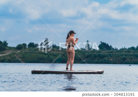 standing woman on supboard 104813191