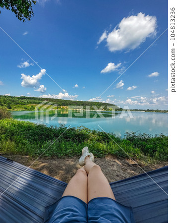 woman pov laying down on hammock looking at the lake woman pov laying down on hammock looking at the lake 104813236