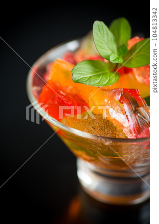 colored sweet fruit jelly in a glass glass colored sweet fruit jelly in a glass glass 104813342