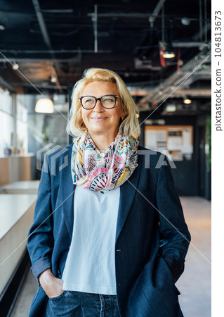 Portrait of smiling 50's stylish, confident mature businesswoman, middle aged company ceo director, experienced senior female professional, business coach team leader in modern office. Female leader Portrait of smiling 50's stylish, confident mature businesswoman, middle aged company ceo director, experienced senior female professional, business coach team leader in modern office. Female leader 104813673