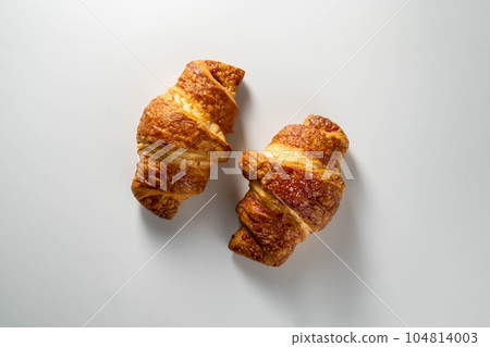Fresh croissants isolated, over white background, top view. Fresh croissants isolated, over white background, top view. 104814003