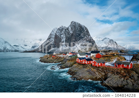 Hamnoy fishing village with red rorbu houses in Norwegian fjord in winter. Lofoten Islands, Norway Hamnoy fishing village with red rorbu houses in Norwegian fjord in winter. Lofoten Islands, Norway 104814228