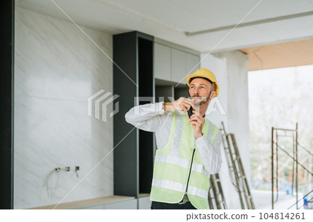 multi ethnic engineer brainstorming and measuring for cost estimating on blueprint and floor plan drawings about design architectural and engineering for houses and buildings. 104814261