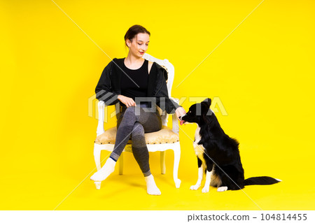 Woman walking and getting exercise for both herself and her border collie dog. Woman walking and getting exercise for both herself and her border collie dog. 104814455
