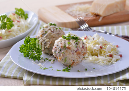 Homemade South Tyrolean bacon dumplings with cabbage salad 104814575