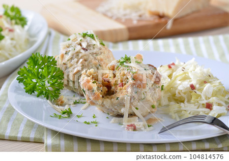 Homemade South Tyrolean bacon dumplings with cabbage salad 104814576