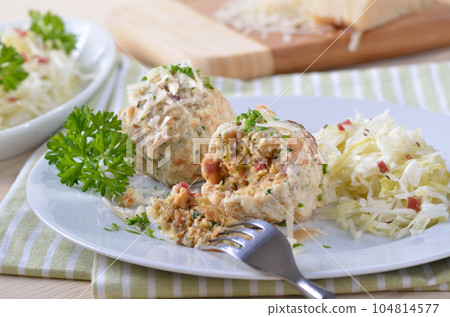 Homemade South Tyrolean bacon dumplings with cabbage salad 104814577