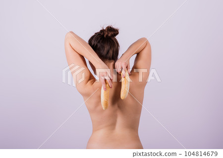 Female sensual body holding one big white bread bun with sesame seeds, horizontal picture Female sensual body holding one big white bread bun with sesame seeds, horizontal picture 104814679