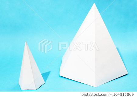 two various hand-crafted paper pyramids on blue two various hand-crafted paper pyramids on blue 104815869